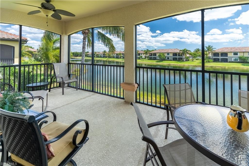 Sunroom / solarium featuring a water view and ceiling fan