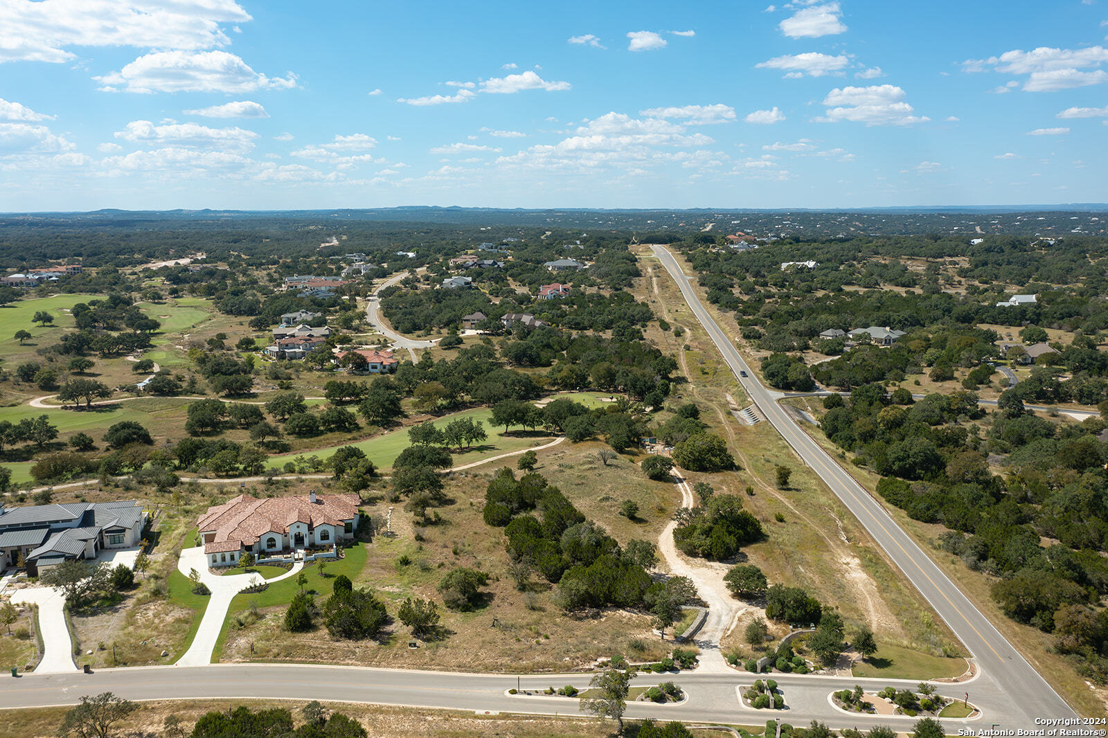 an aerial view of residential houses with outdoor space