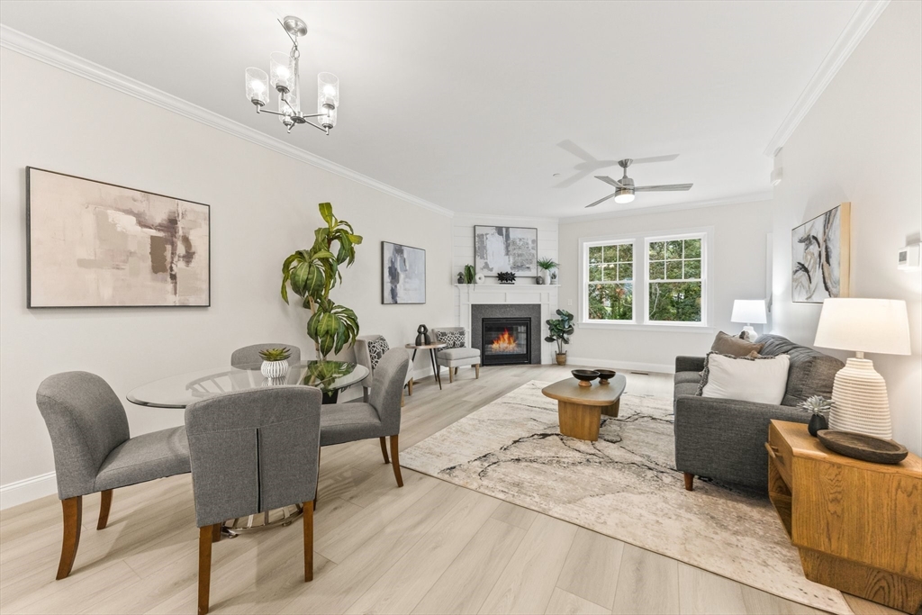 a living room with furniture a chandelier and a fireplace