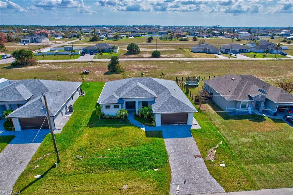 an aerial view of a house with a swimming pool yard and outdoor seating