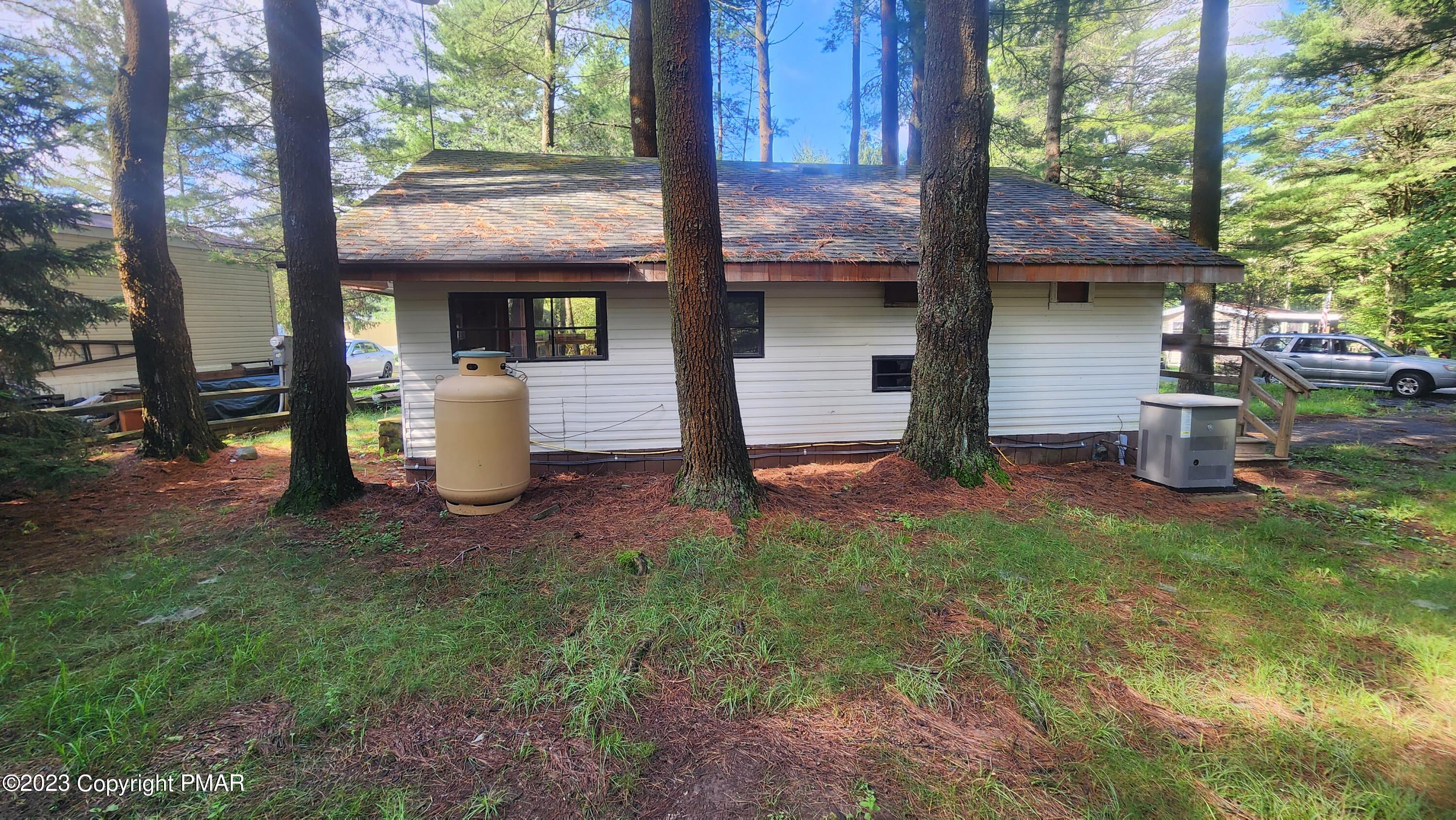 a view of a house with backyard and sitting area