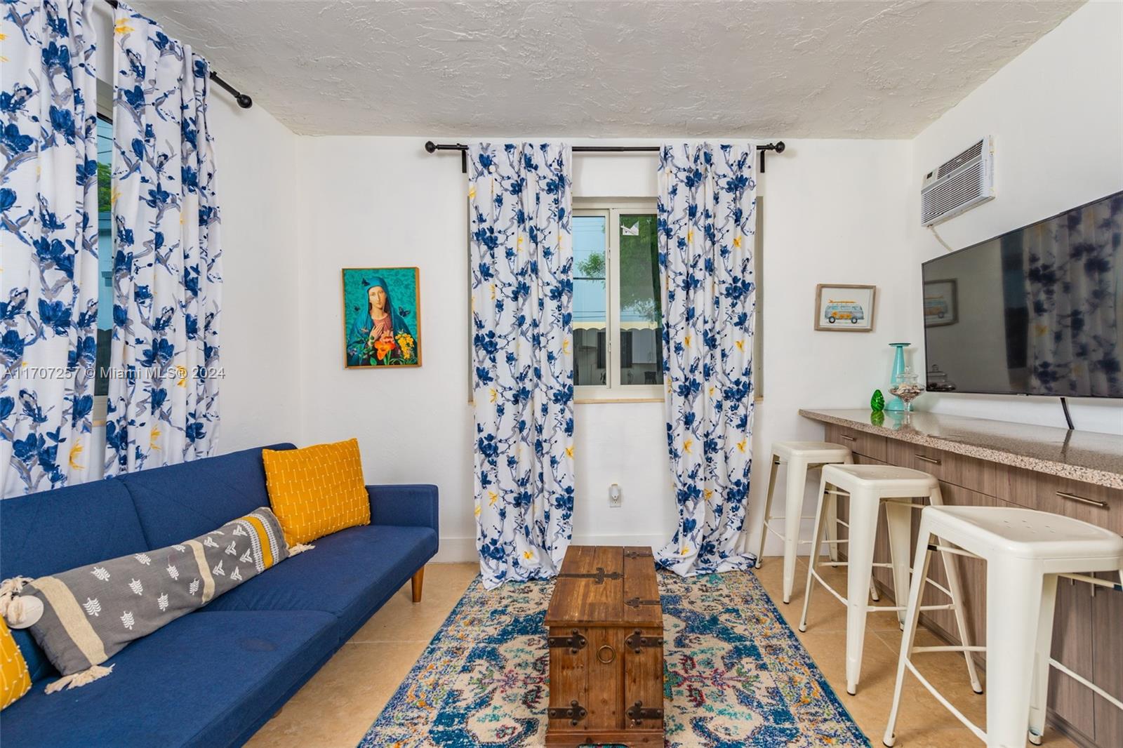 a living room with furniture and a rug