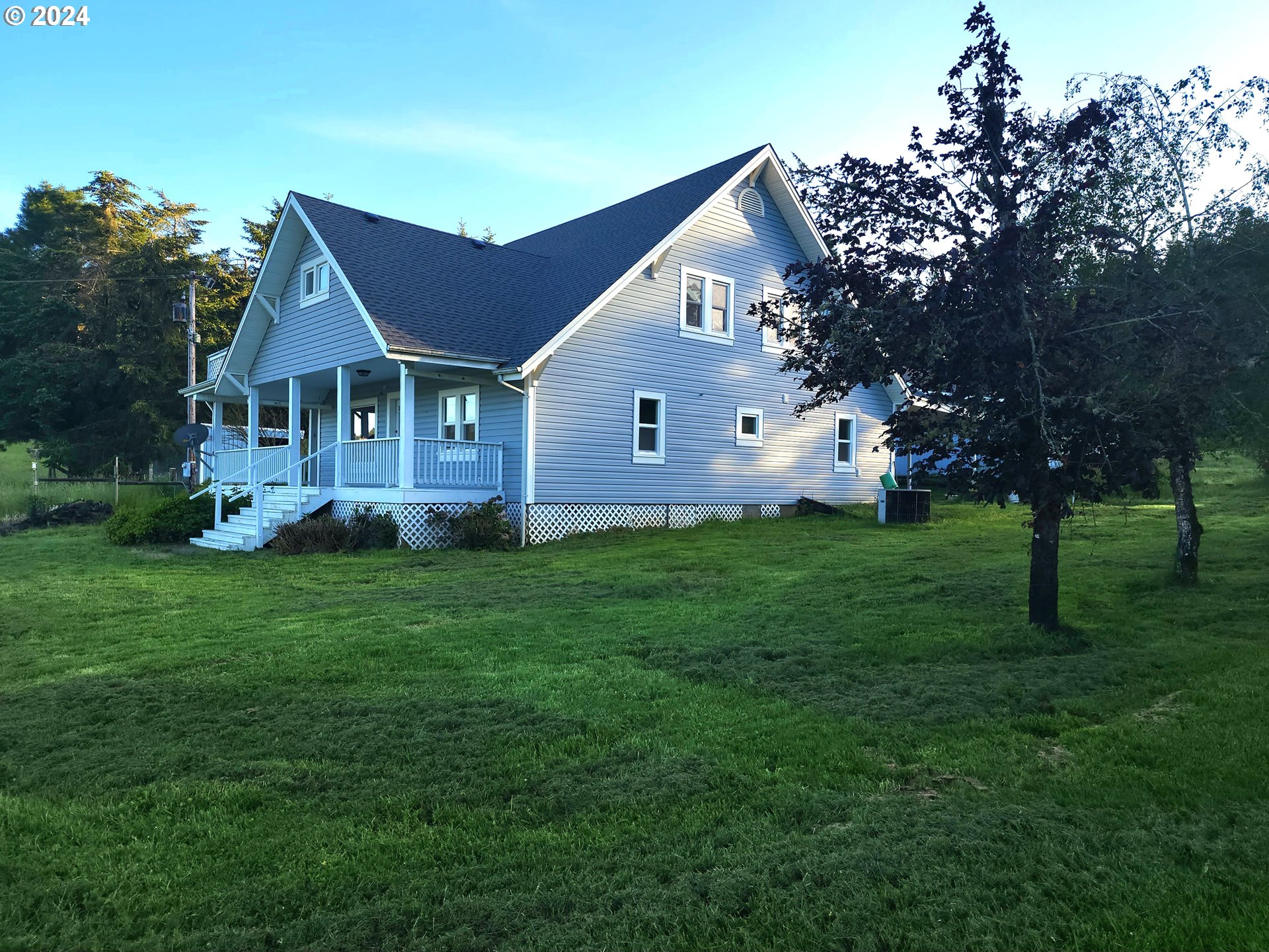 a front view of house with yard and green space