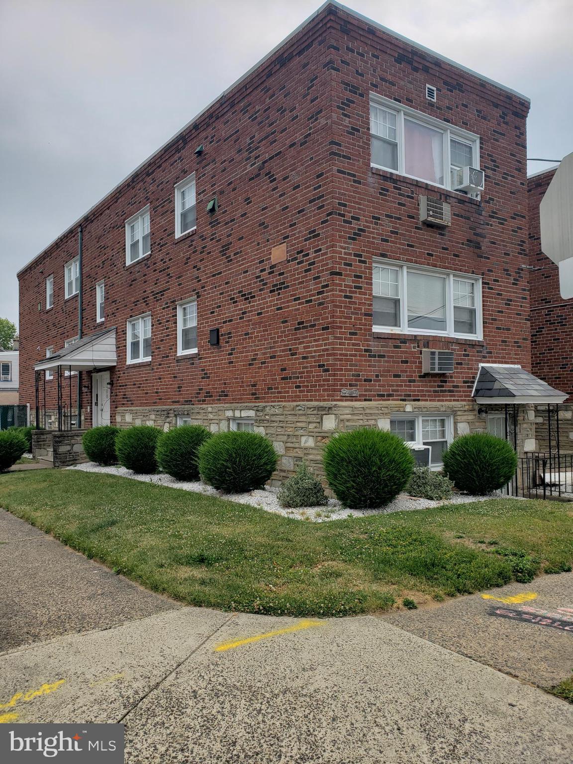 a view of a brick building next to a yard