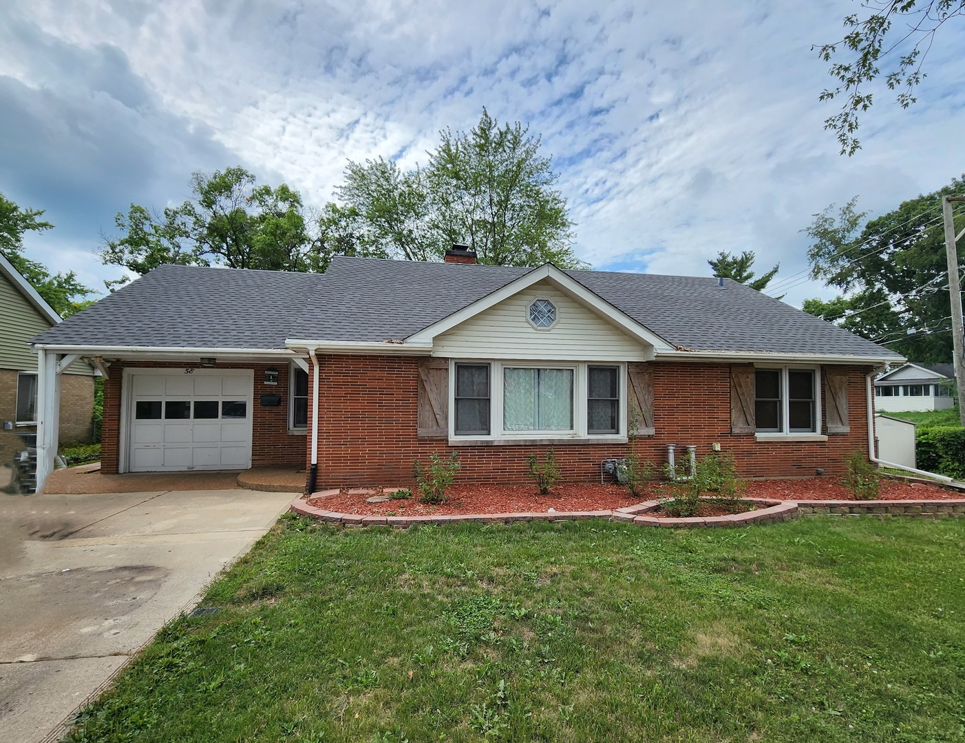 a front view of house with yard and outdoor seating