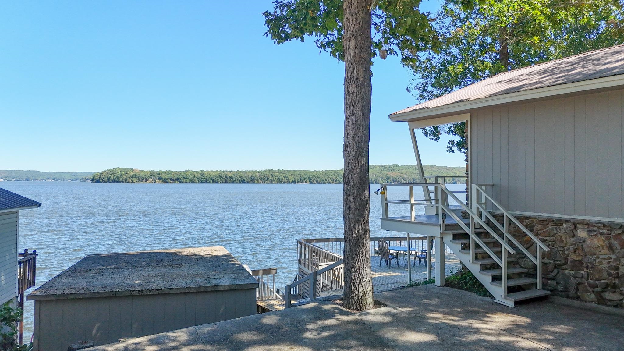 a wooden bench sitting next to a lake