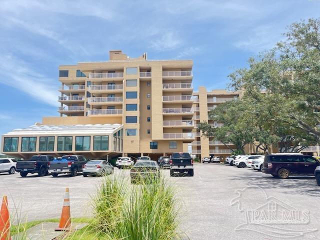 a view of a building with patio area and swimming pool