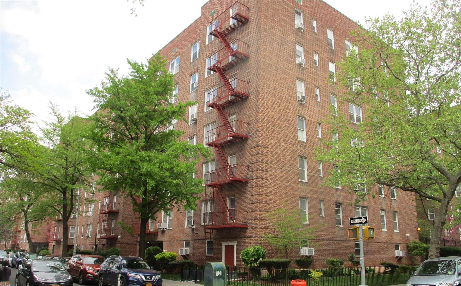 a view of a tall building with large trees