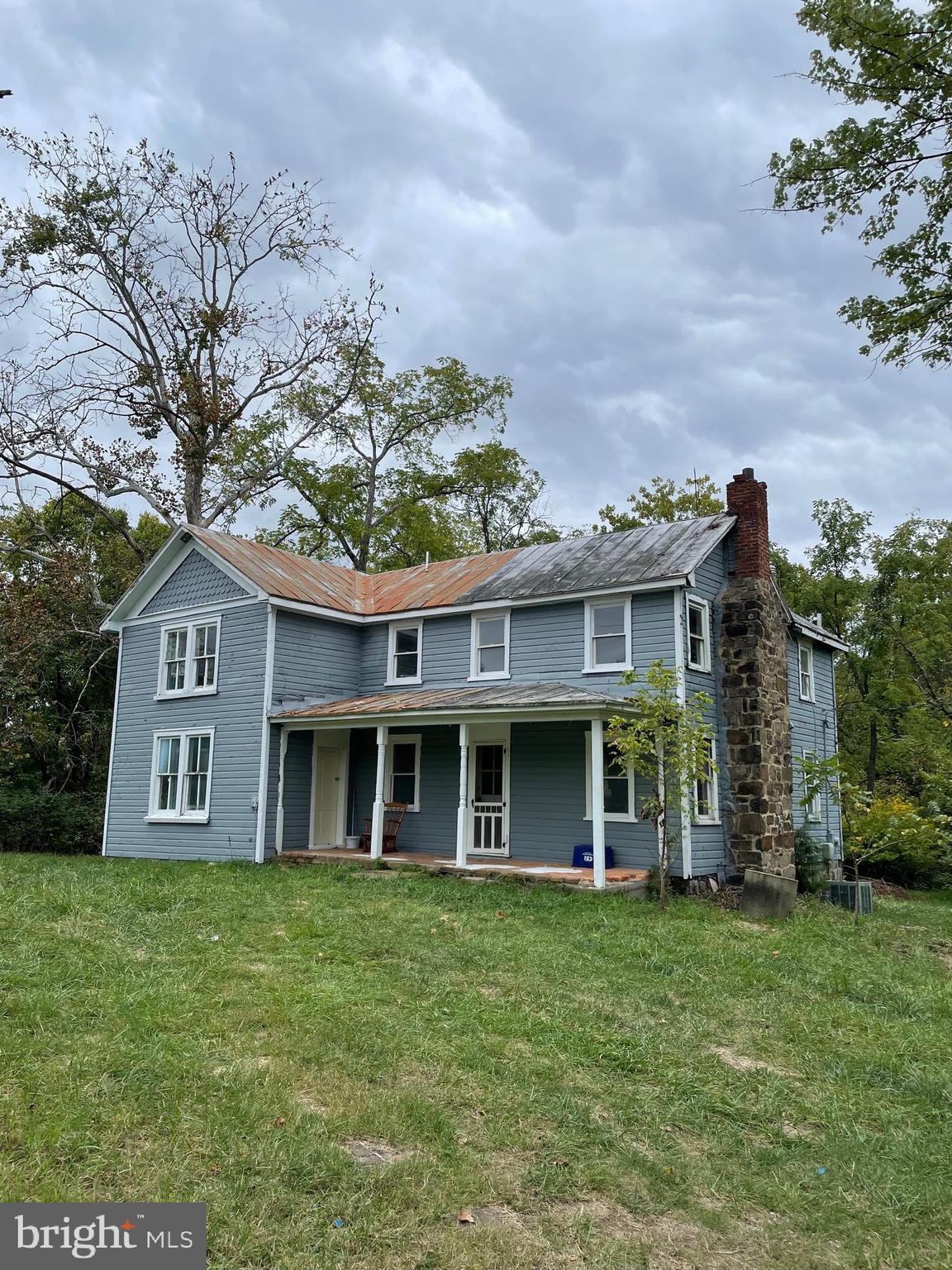 front view of a brick house with a yard