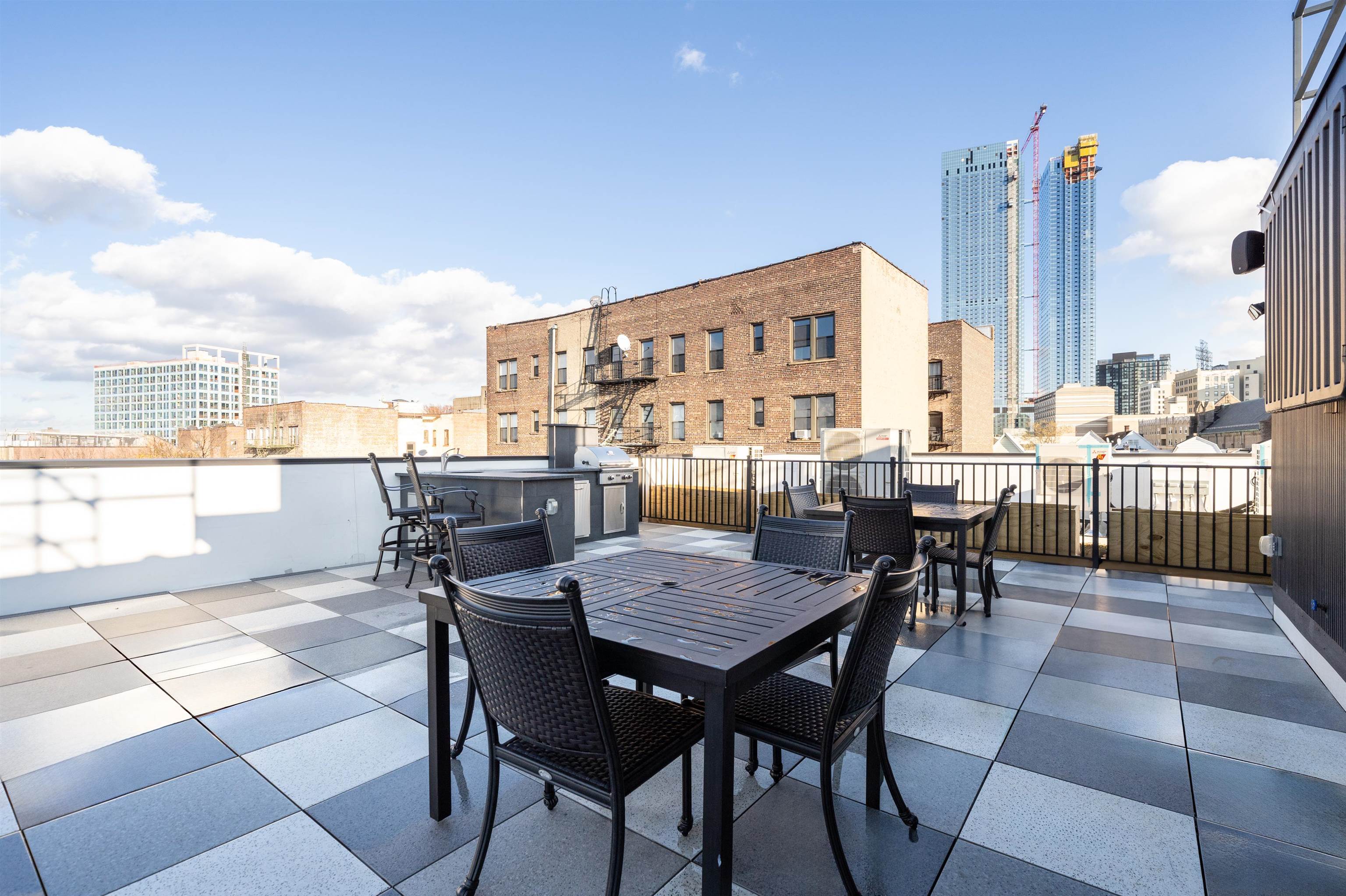 a view of a roof deck with table and chairs