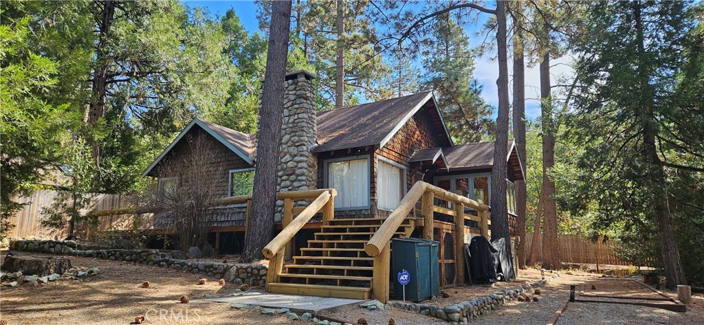 a view of a house with a tree front of house