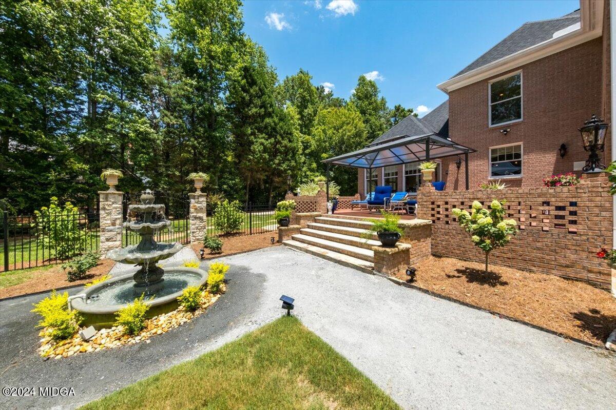 a view of a house with backyard outdoor seating area and swimming pool