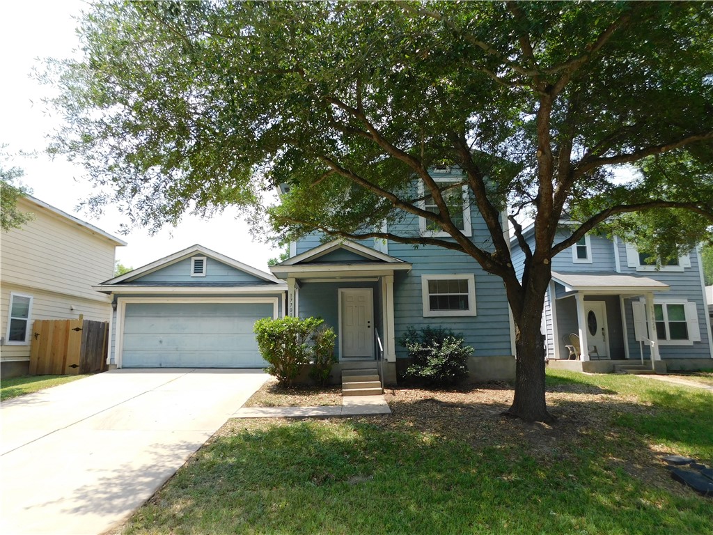 a front view of a house with a garden and yard