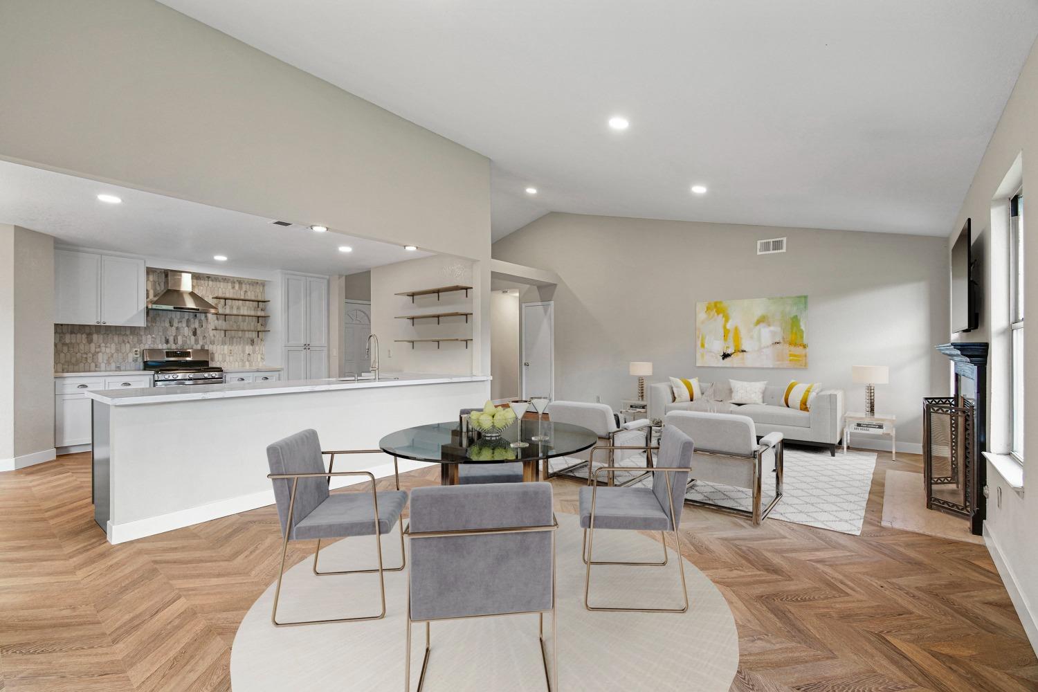 a living room with furniture and kitchen view