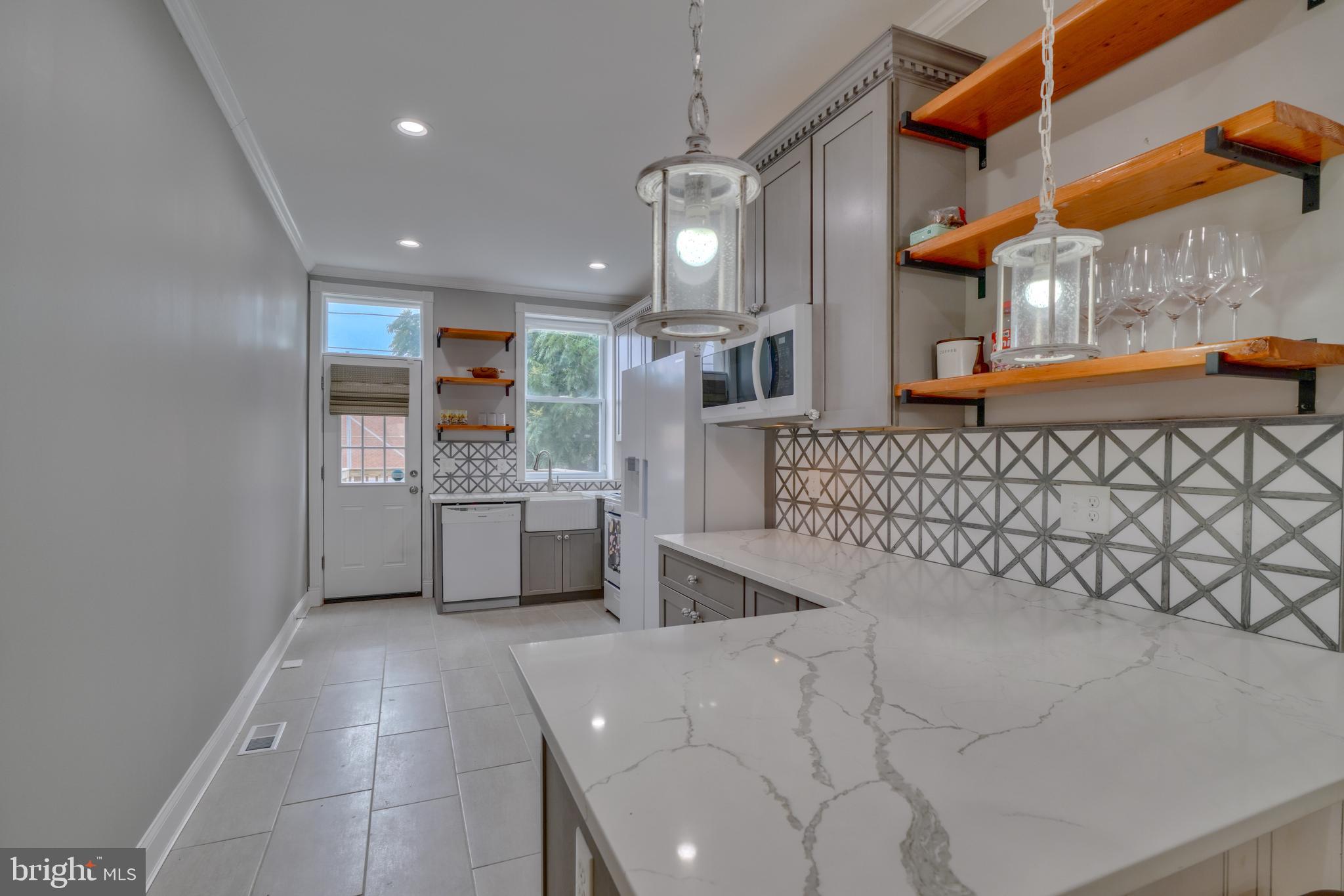 a large white kitchen with a large window