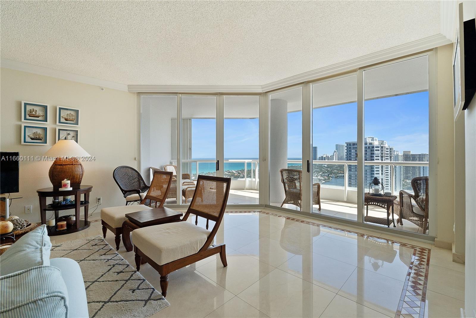 a living room with furniture and a floor to ceiling window