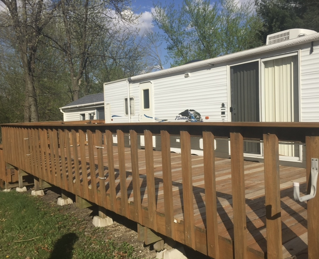 a side view of a house with a wooden deck