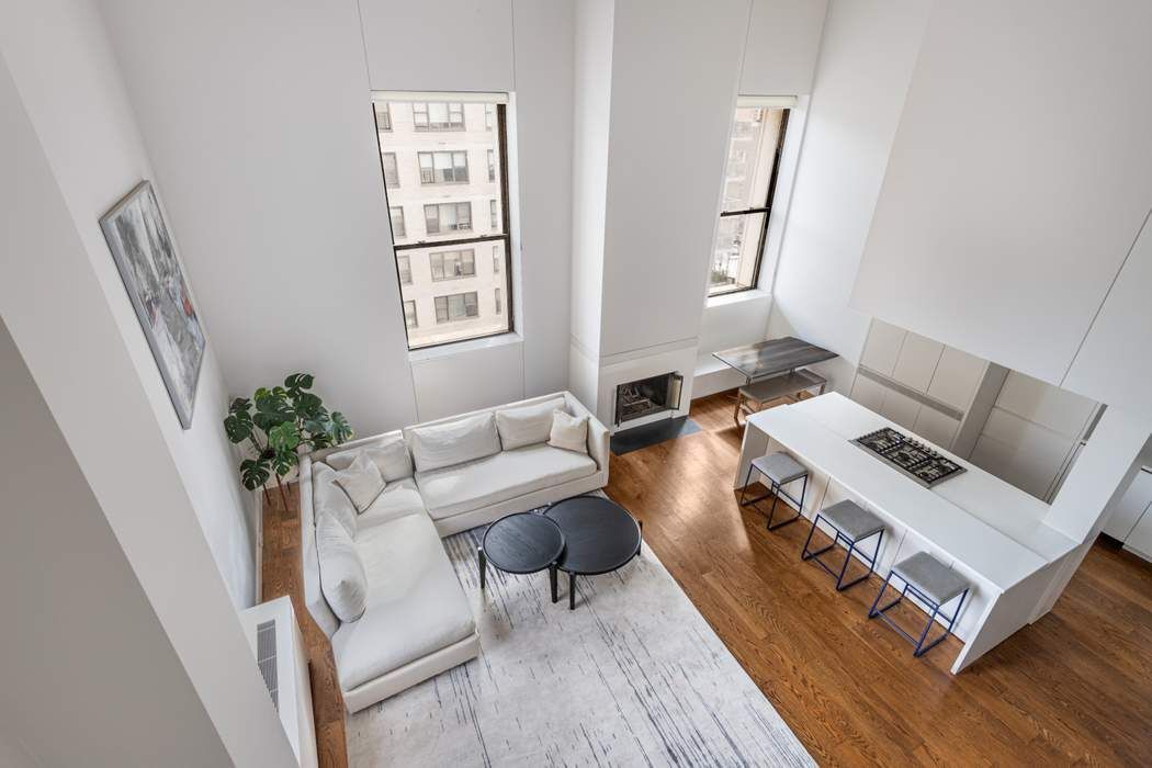 a living room with furniture and a potted plant