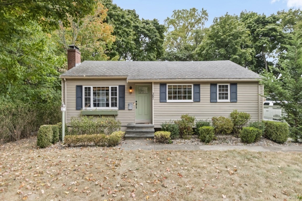 a front view of a house with a garden