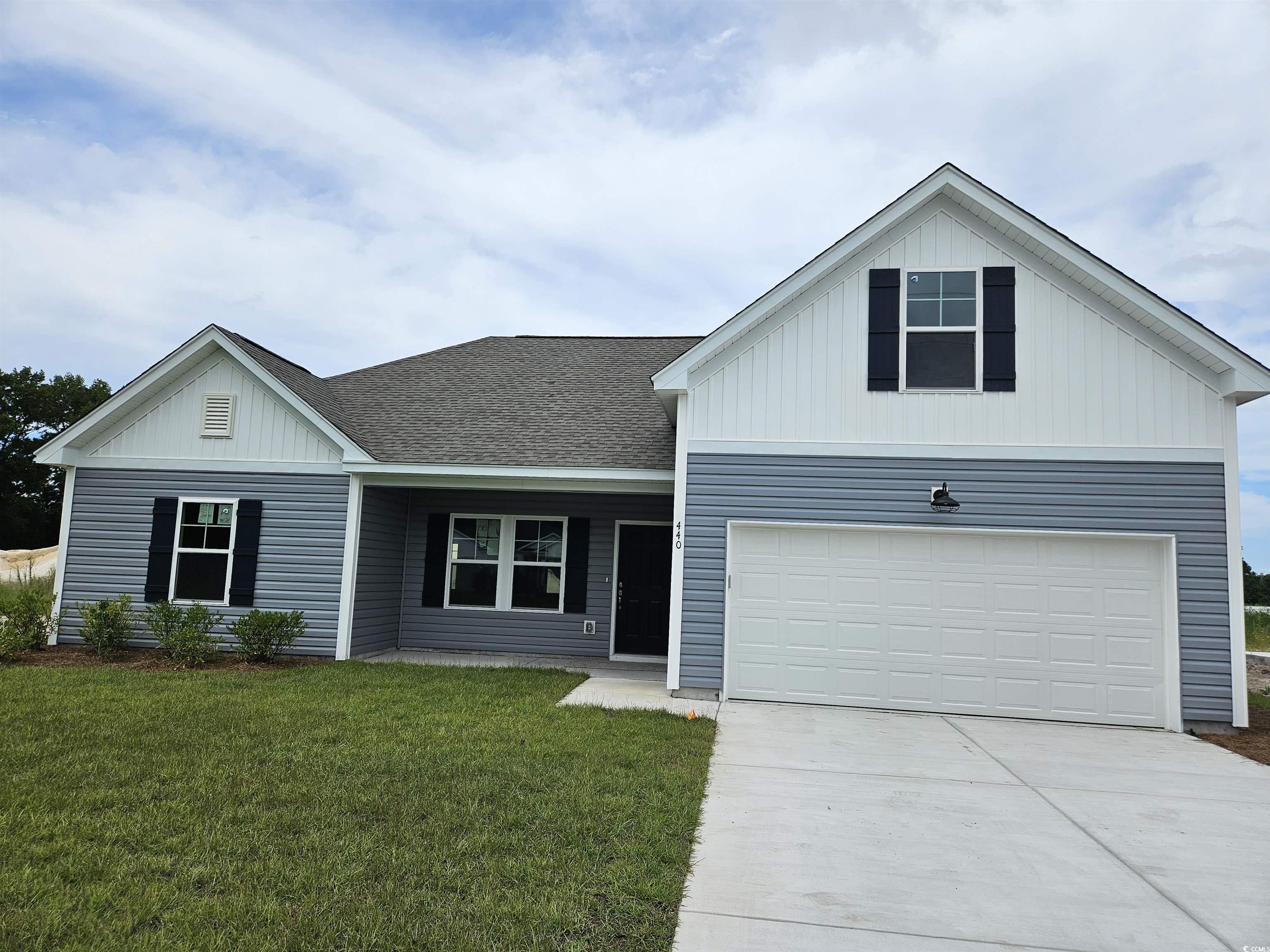 View of front facade featuring a garage and a fron