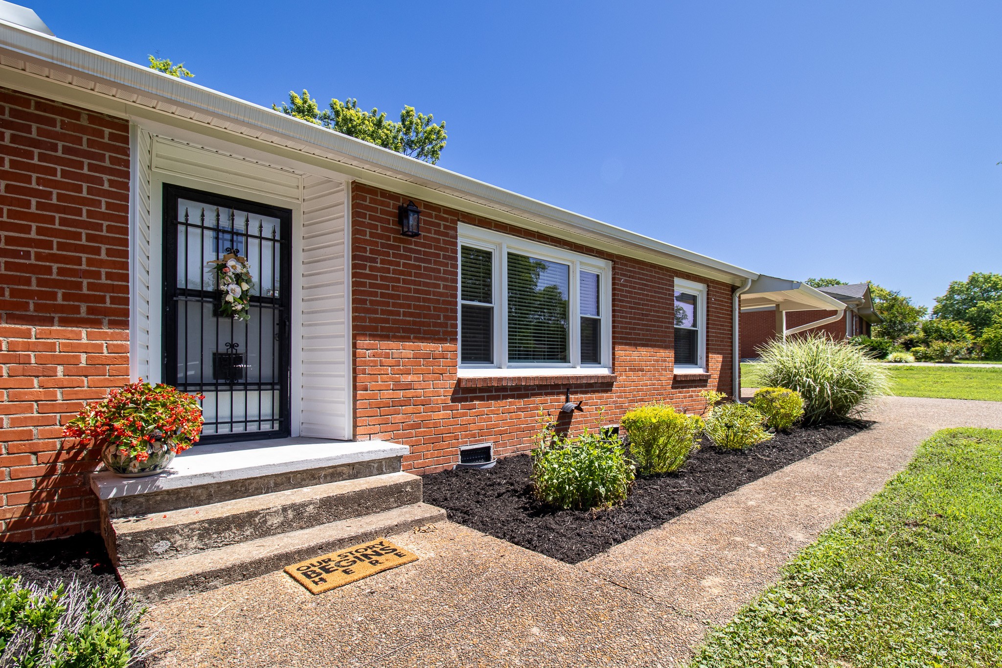 a front view of a house with a garden