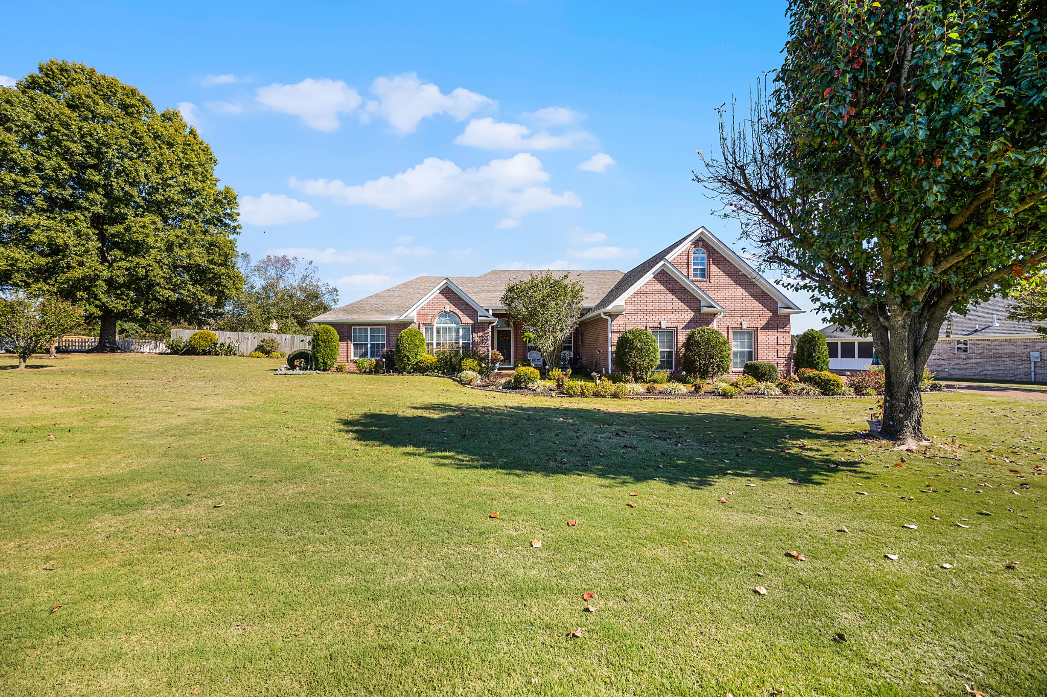 a front view of house with yard and green space