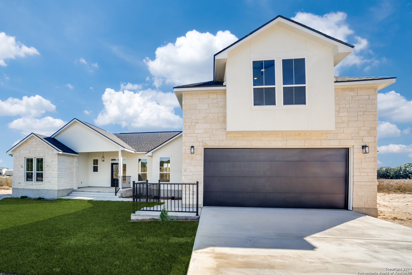 a front view of a house with a yard and garage