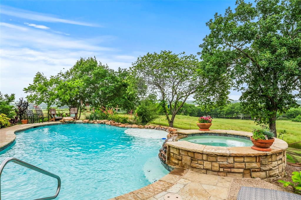 a view of a backyard with swimming pool