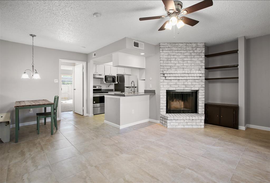 a view of a kitchen with a stove cabinets and a fireplace