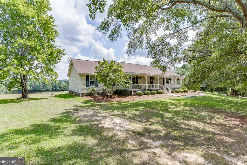 a front view of a house with yard and green space