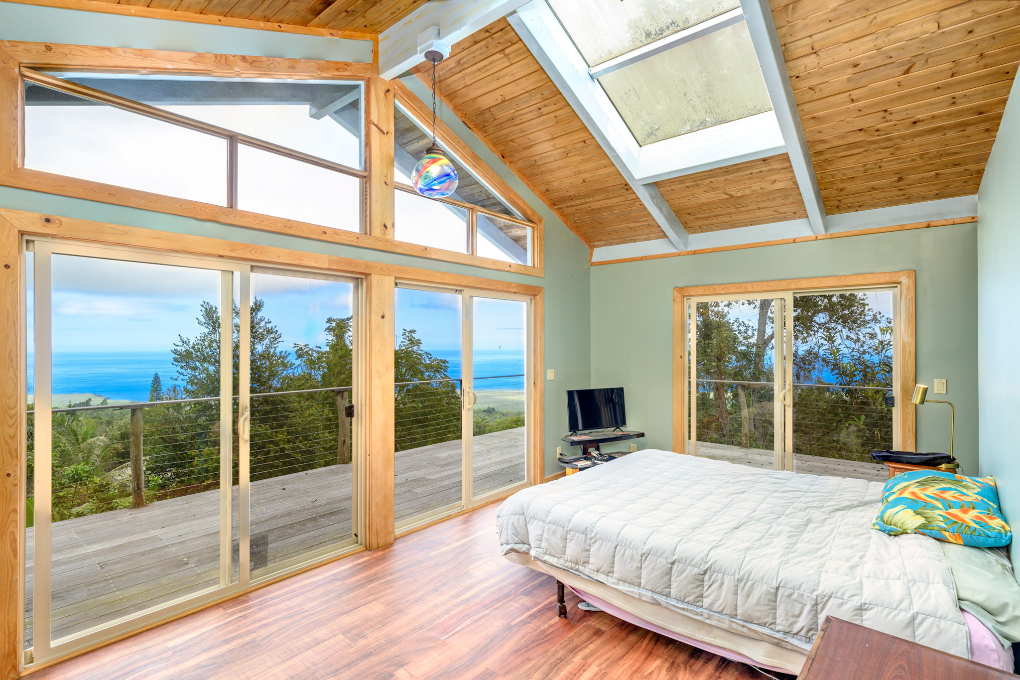 a bedroom with a bed and glass door