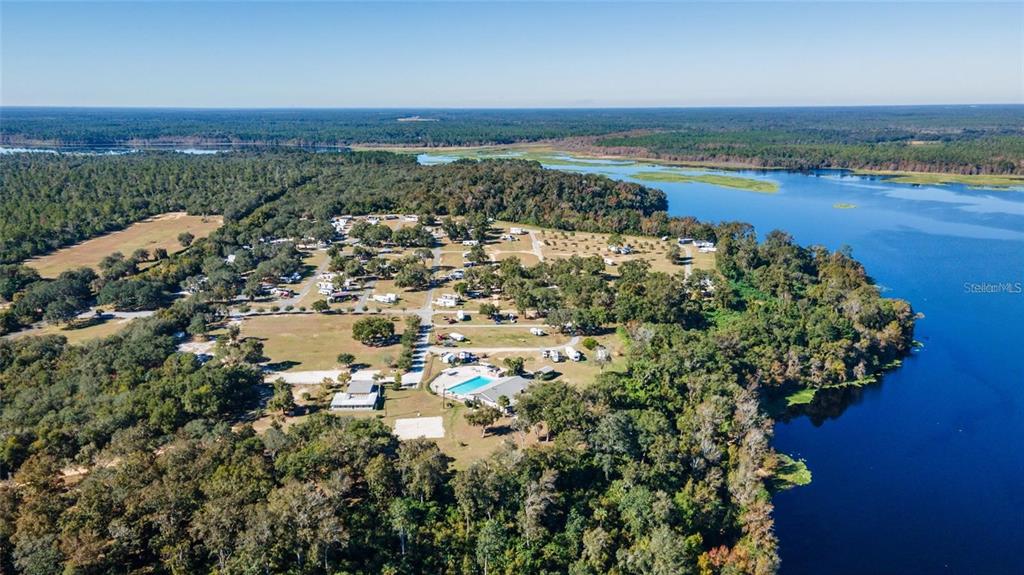 an aerial view of a house with a lake view