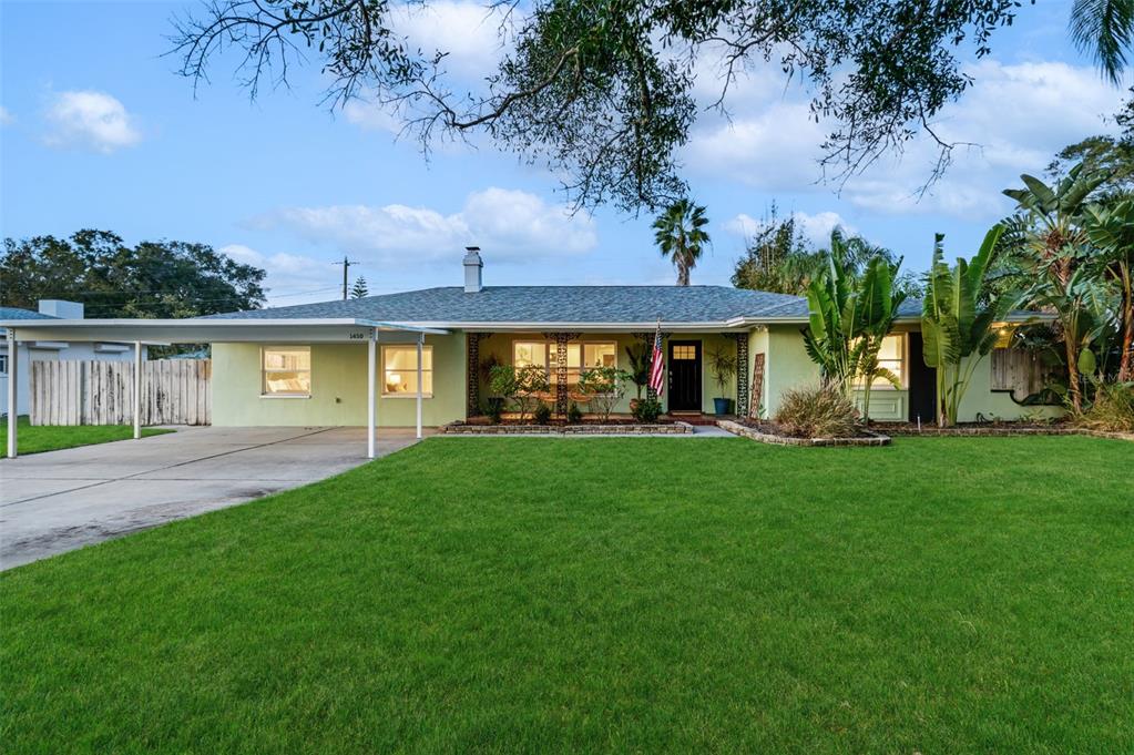 a view of an house with backyard space and garden