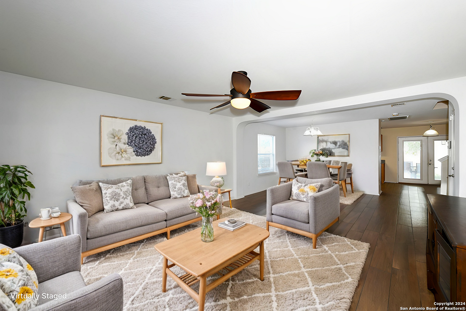 a living room with furniture and a chandelier