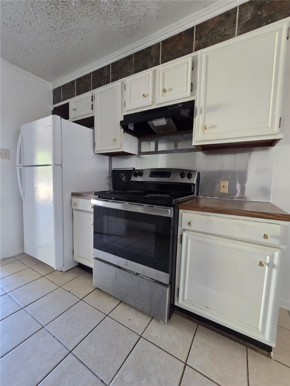 a kitchen with stainless steel appliances a stove a microwave and a refrigerator