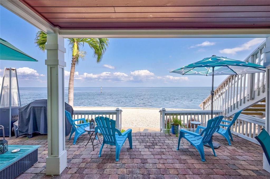 a view of a patio with a table and chairs under an umbrella