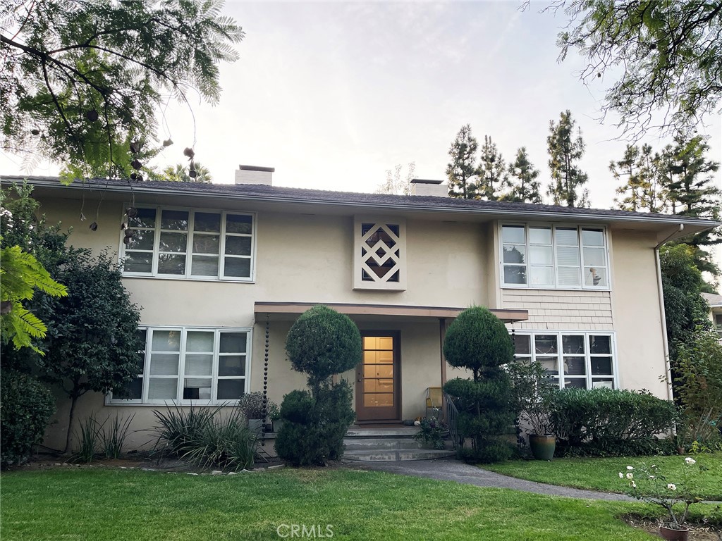 a front view of a house with garden