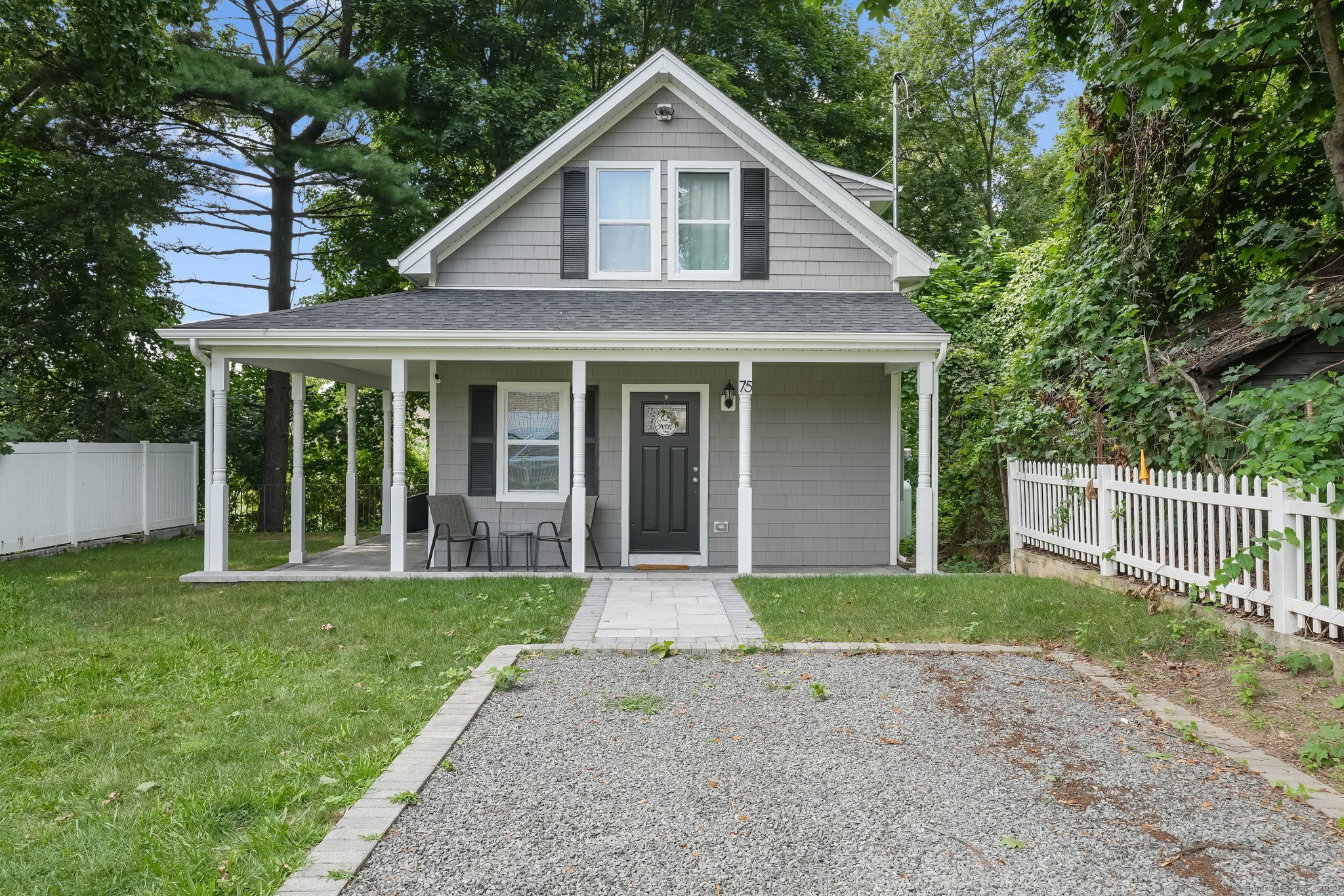 a front view of a house with a yard and porch