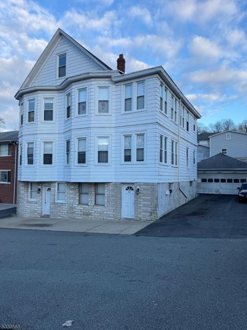 a view of a big house with a street