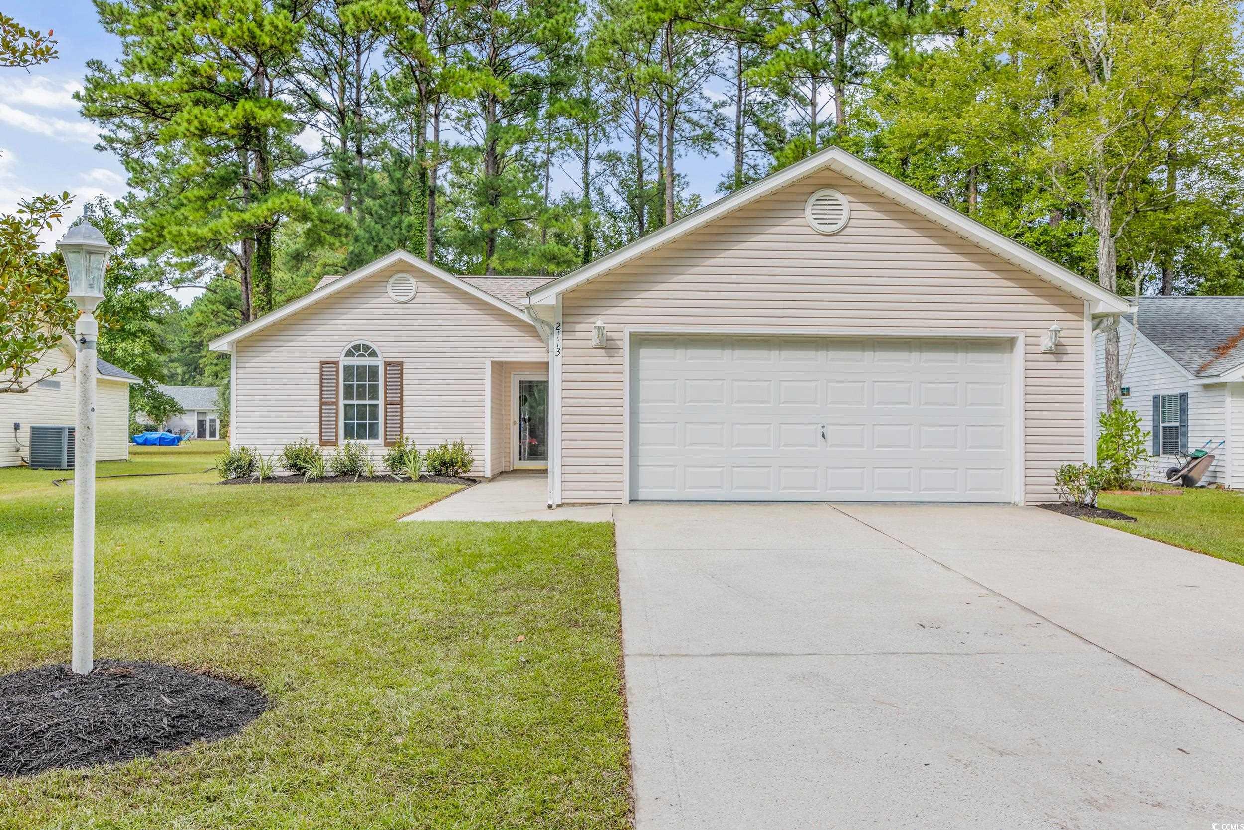 Single story home featuring a front yard, a garage