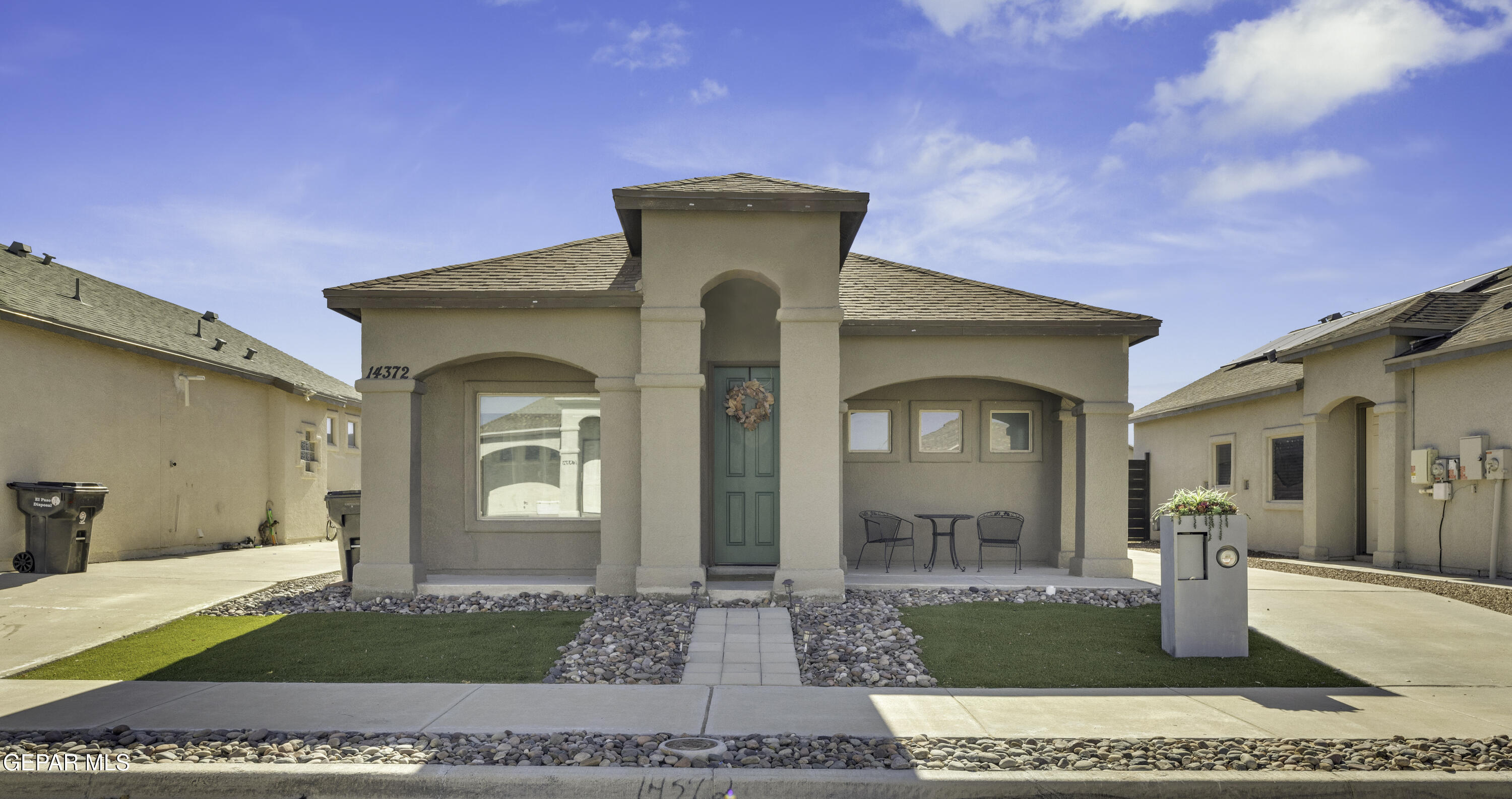 a front view of a house with garden