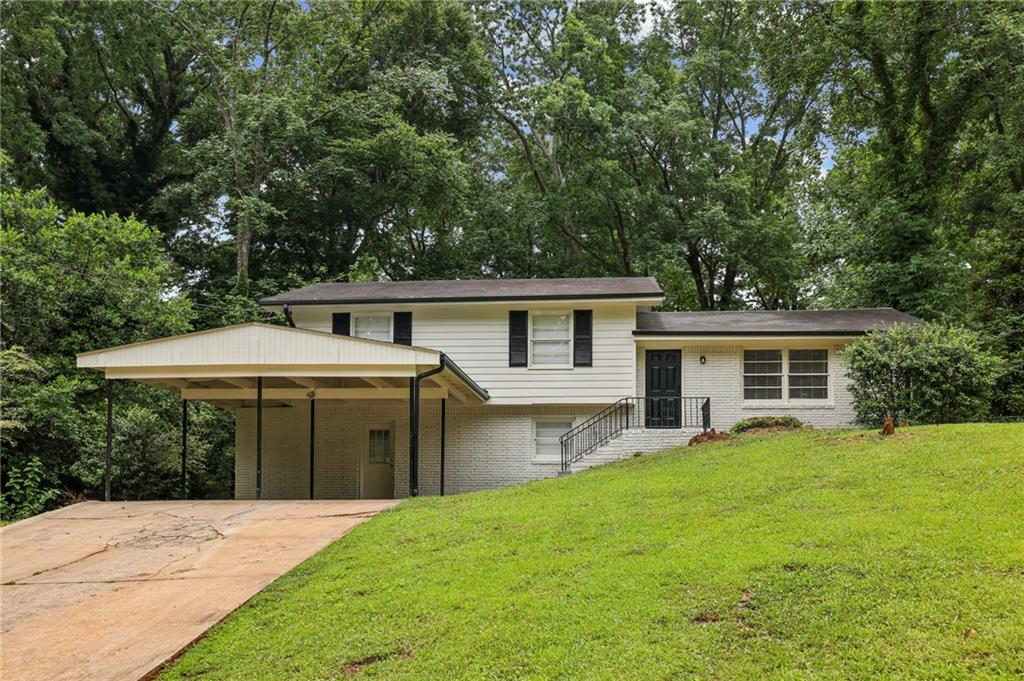 a front view of house with yard and green space