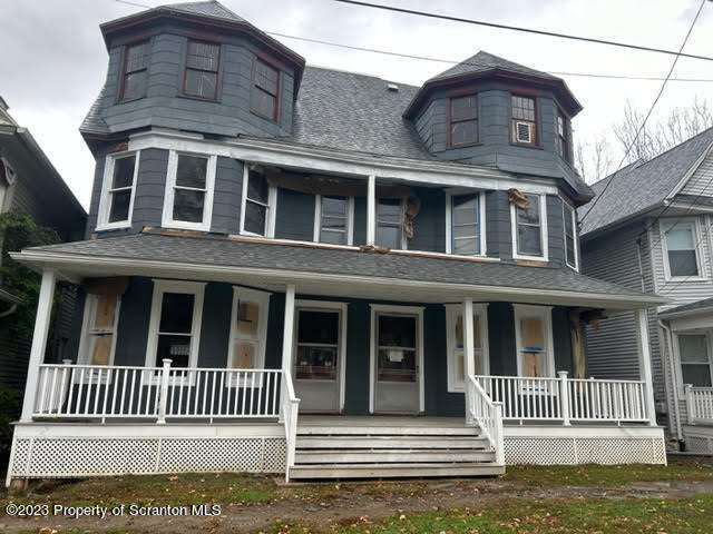 a front view of a house with a fence