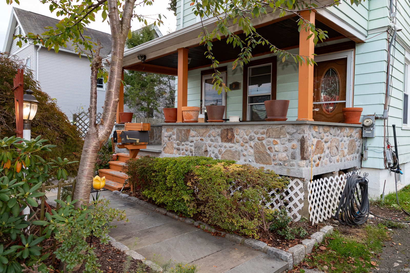 front view of a house with a large tree