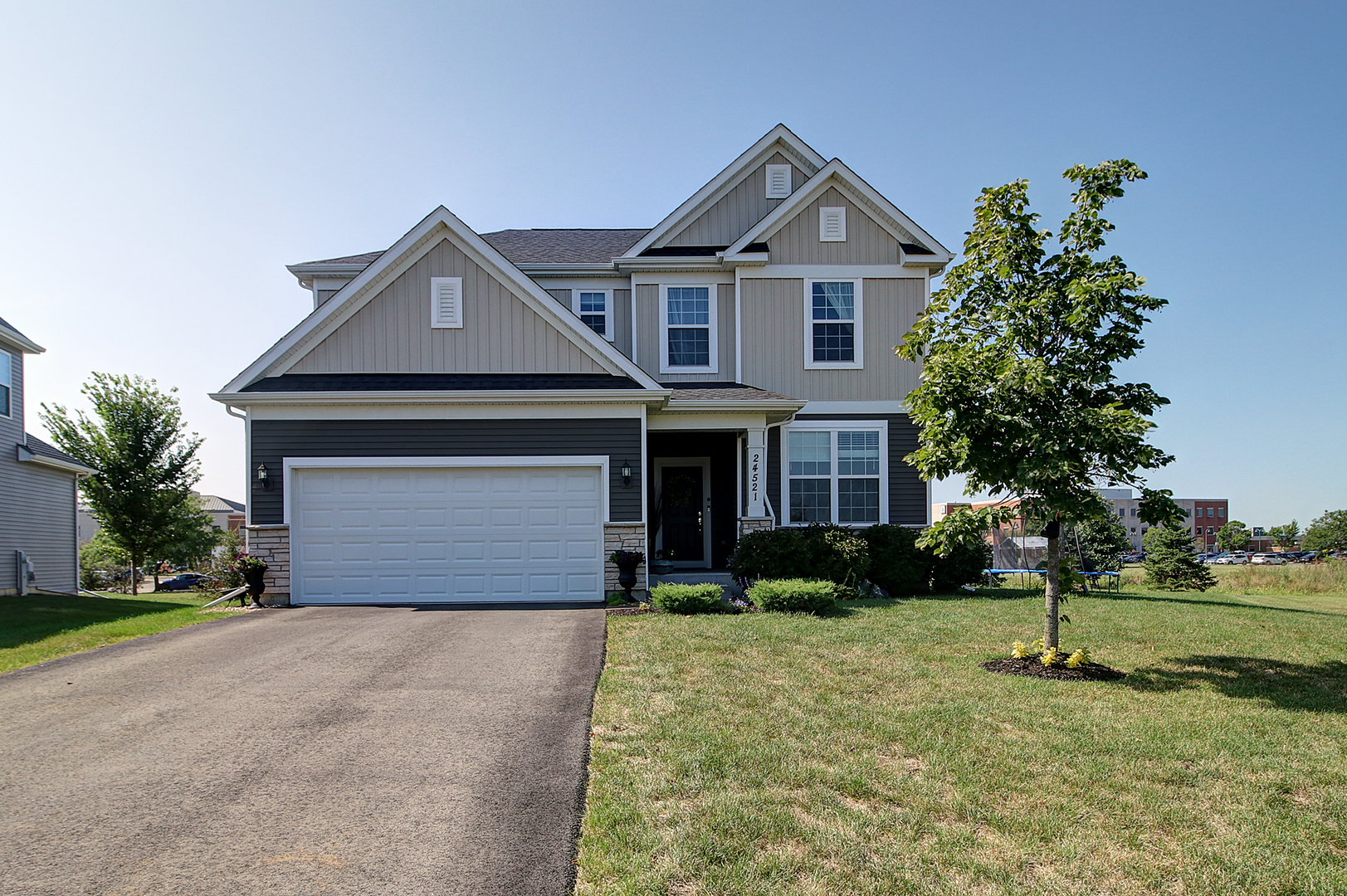 a front view of a house with a yard and garage