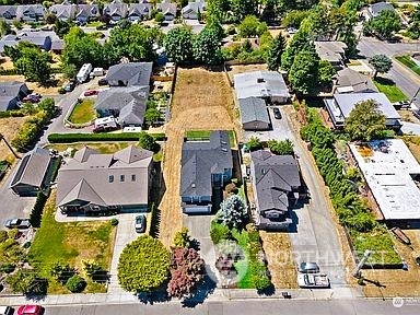 an aerial view of residential houses with outdoor space and street view