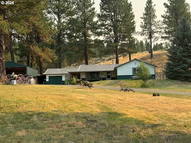 a view of a house with a yard and sitting area