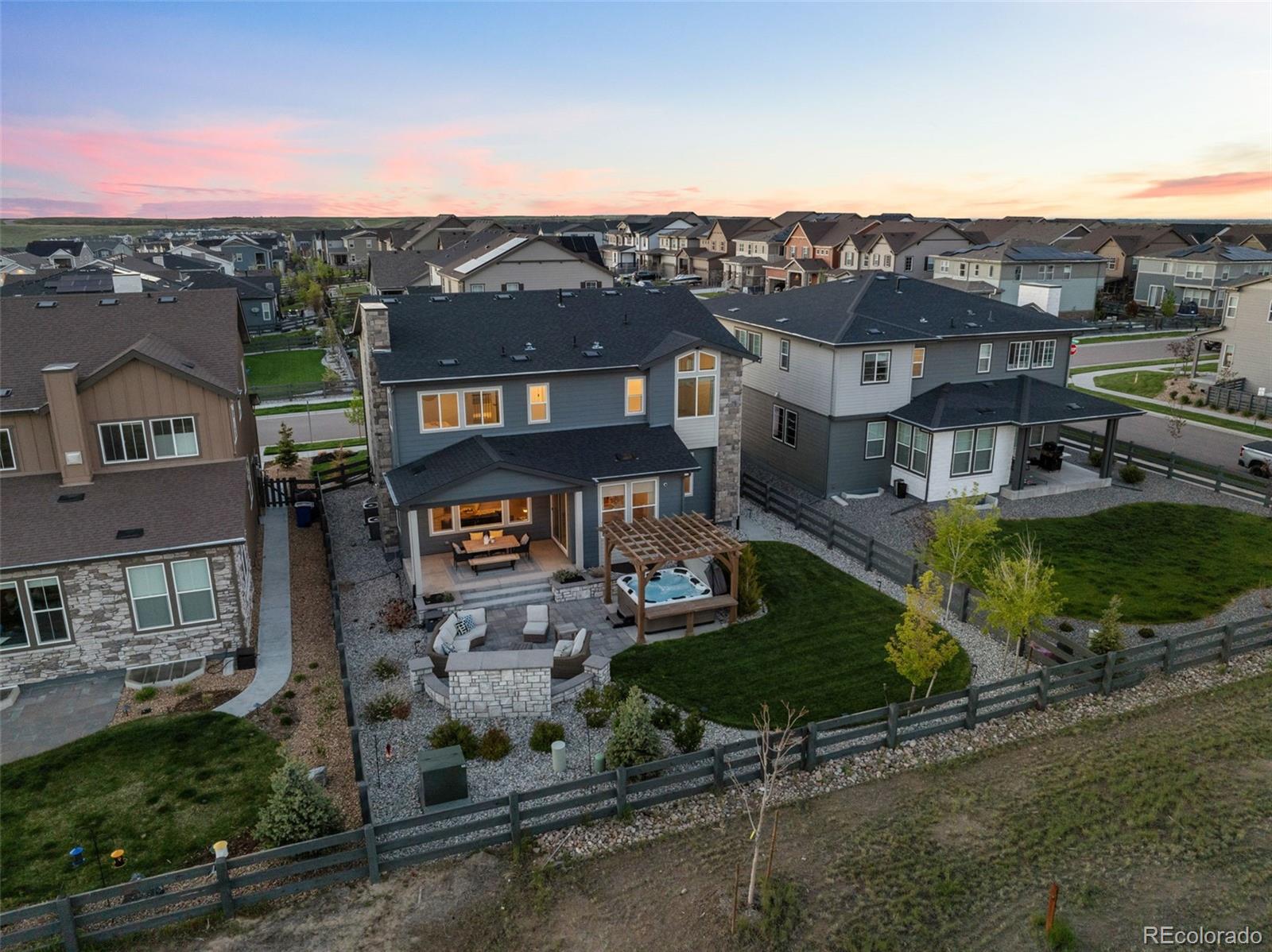 an aerial view of residential houses with a yard