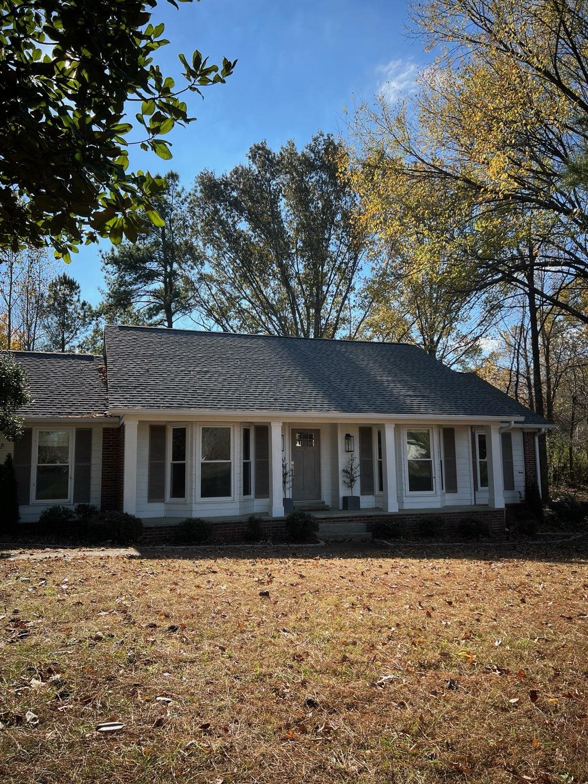 Ranch-style home featuring a front lawn