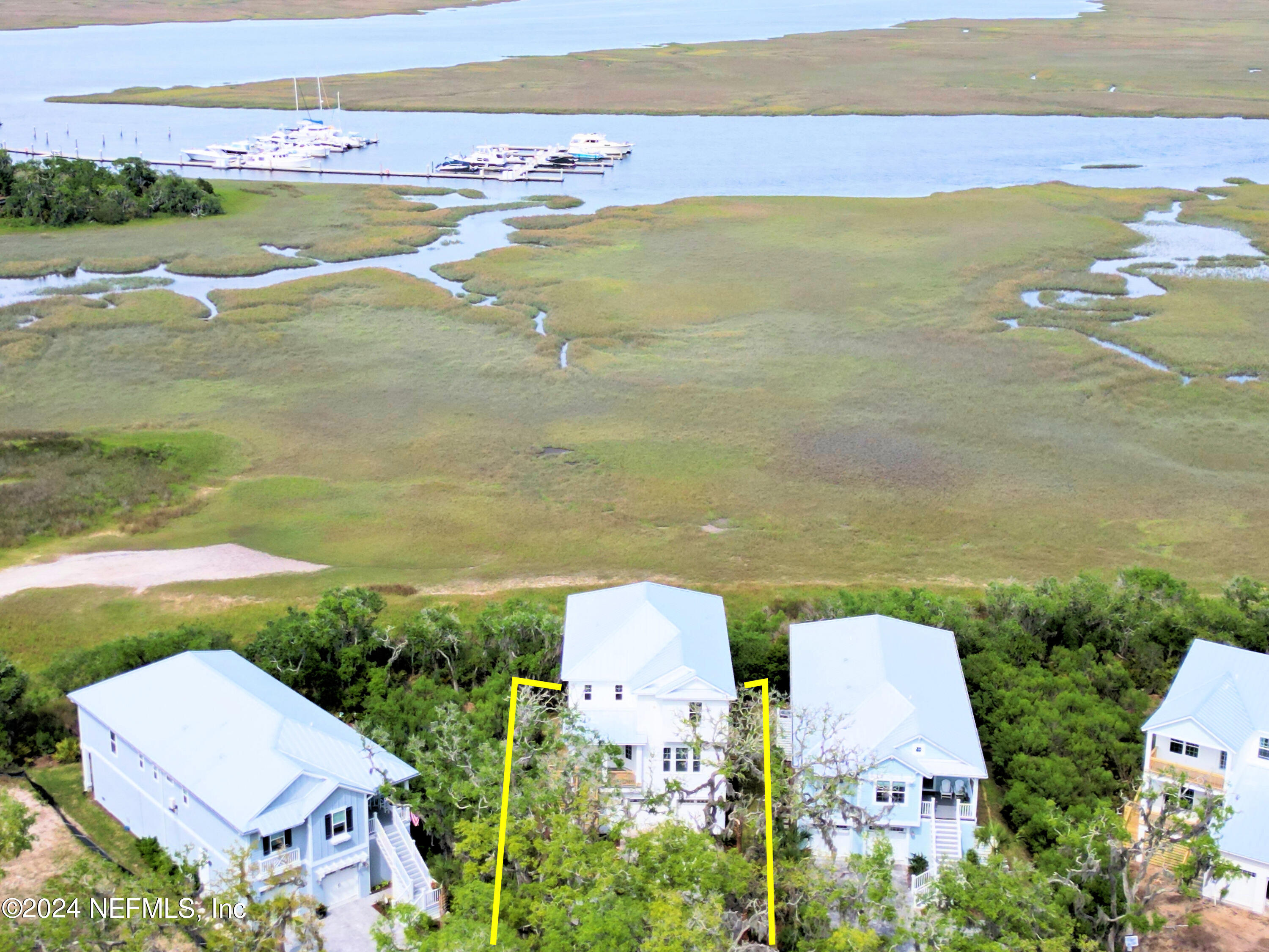 an aerial view of ocean with residential houses with outdoor space